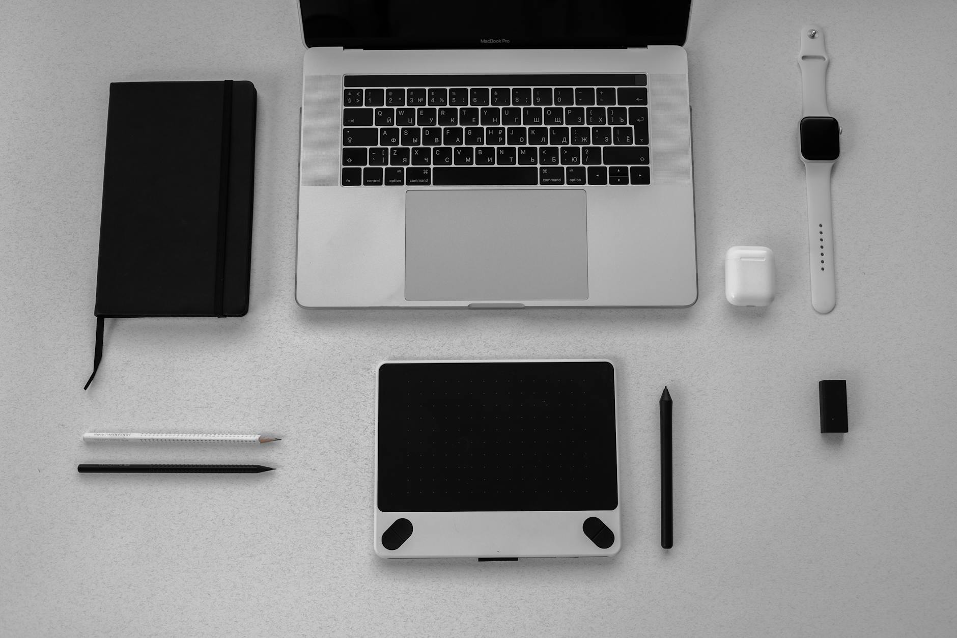 black notebook beside a macbook pro